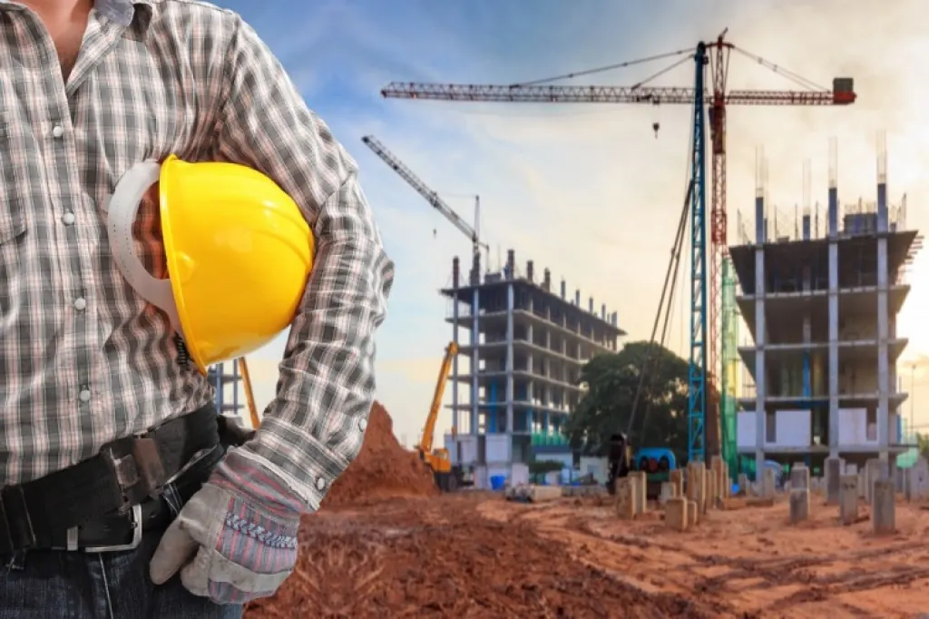 Engenheiro com capacete em frente a obra