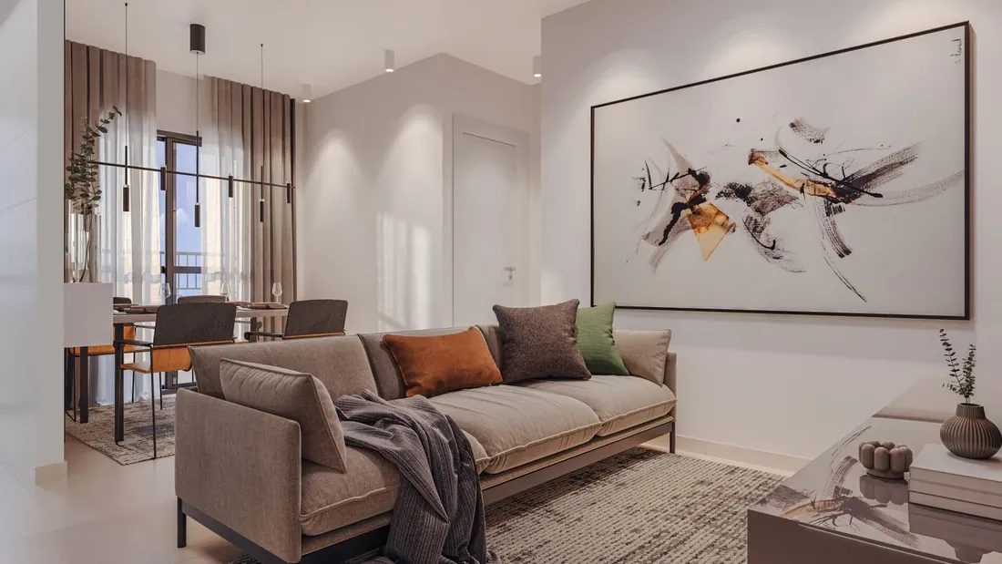 Sala de estar com sofá e quadro, integrada à sala de jantar